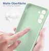 A hand is touching a light green phone case, highlighting its matte surface and soft grip. Produktbild-Vorschau