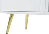 A close-up view of the bottom part of a white cabinet with gold metal legs. Produktbild-Vorschau
