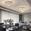 A dining room with two crystal chandeliers, a dining table set for a meal, and a sofa in the background. Produktbild-Vorschau