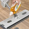 A hand is pouring cleaning liquid from a bottle onto a mop head. Podgląd zdjęcia produktu