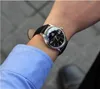 A person wearing a blue shirt and a watch. Produktbild-Vorschau