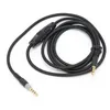 A black audio cable with 3.5mm connectors and an in-line volume control, laid out on a white background. Náhľad obrázku produktu