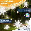 Outdoor scene at night with illuminated star-shaped lights on the ground and hanging. Produktbild-Vorschau
