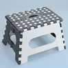 A folding step stool shown on a light blue background. Podgląd zdjęcia produktu