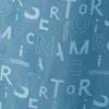 A close-up of a blue fabric with a repeating pattern of white letters and the brand name 'AMERICAN TOURISTER'. Produktbild-Vorschau