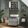 A modern bathroom with a green tiled wall, a vanity with a sink and drawers, a medicine cabinet, and a shelving unit. Voir les images du produit