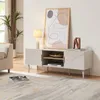A modern living room scene featuring a beige TV stand with decorative items and artwork. Voir les images du produit