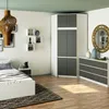 A bedroom scene featuring a corner wardrobe, bed, dresser, and decorative items. Anteprima dell’immagine prodotto
