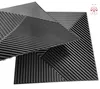 A close-up, angled view of several black 3D wall panels with a ribbed texture, arranged in a geometric pattern. Produktbild-Vorschau