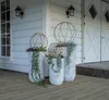 Decorative LED spheres in planters on a wooden porch. Produktbild-Vorschau