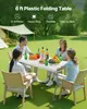 A family is having a picnic outdoors at a table. Produktbild-Vorschau