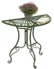 A green metal half-round table with a potted plant and a book on it, set against a white background. Náhled obrázku produktu