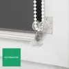 A close-up view of a roller blind mechanism, showing the chain and its holder. Produktbild-Vorschau