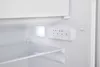 Close-up view of the interior of a refrigerator, showing a control panel and a shelf. Produktbild-Vorschau