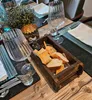 A table setting with a wooden box of bread, wine glasses, and a decorative lantern. Podgląd zdjęcia produktu