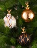 Three Christmas ornaments hanging on a Christmas tree. Podgląd zdjęcia produktu