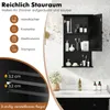 A black bathroom cabinet with its door open, displaying various toiletries and personal care items, is shown above a sink. Text overlays highlight storage capacity and adjustable shelf features. Podgląd zdjęcia produktu