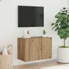 A modern living room setup with a wall-mounted TV and a wooden cabinet below it. Voir les images du produit