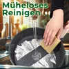 A person is washing a black frying pan with white soap in a sink, with water running from a faucet. Anteprima dell’immagine prodotto