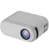 A gray mini projector is shown from a diagonal angle against a white background. Voir les images du produit