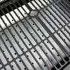 A close-up view of a grill grate with small holes. Podgląd zdjęcia produktu