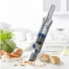 A handheld vacuum cleaner is shown on a kitchen counter, cleaning up crumbs. Náhled obrázku produktu
