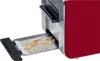 A close-up view of a red toaster with its crumb tray extended, showing crumbs inside. Produktbild-Vorschau