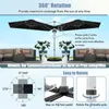 An outdoor patio scene with a large black cantilever umbrella, furniture, and plants. Náhled obrázku produktu