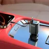 A car's interior with a phone charging via a car charger. Produktbild-Vorschau