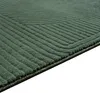 A close-up view of a green rug with a geometric pattern. Podgląd zdjęcia produktu