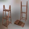 Three wooden plant stands of different sizes are displayed against a gradient background. Produktbild-Vorschau