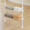 A white wire shelving unit with folded towels and a plastic container on it, placed on a light wood floor. Produktbild-Vorschau