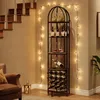 A wine rack is placed in a corner next to a staircase, decorated with string lights. Náhľad obrázku produktu