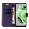 A purple flip cover phone case with card slots and a banknote is shown open, revealing a smartphone with a green abstract wallpaper. Produktbild-Vorschau