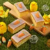 Easter-themed cakes decorated with carrots and chicks on a grassy background. Produktbild-Vorschau