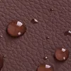 A close-up view of a brown textured surface with water droplets on it. Podgląd zdjęcia produktu