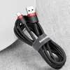 A coiled black and red USB-C charging cable with a velcro strap. Náhľad obrázku produktu