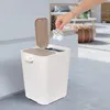 A hand is shown dropping a crumpled piece of paper into a dual-compartment trash can. Náhľad obrázku produktu