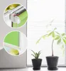 Close-up views of a green roller blind system, showing mounting details and a measurement. Produktbild-Vorschau