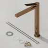 A rose gold faucet and its installation accessories are laid out on a light gray surface. Produktbild-Vorschau