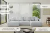 A large, light gray U-shaped sectional sofa is shown in a modern living room setting with large windows and sheer curtains. Produktbild-Vorschau