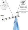 A stainless steel over-the-door hook rack with text overlays describing its features and material. Anteprima dell’immagine prodotto