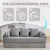 A grey sofa is shown in a room with a bookshelf in the background. Above the sofa, there are three icons illustrating the compression and expansion process of the sofa. Anteprima dell’immagine prodotto