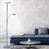 A modern living room with a blue sofa, coffee table, and a floor lamp. Anteprima dell’immagine prodotto