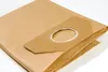 A folded paper vacuum cleaner bag with a cardboard collar and opening. Produktbild-Vorschau