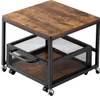 A square side table with a wood-grain top and a mesh basket shelf below, all supported by a black metal frame with casters. Voir les images du produit