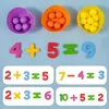 A Montessori learning set for children, featuring colorful counting balls and number tiles arranged on a light blue background. Produktbild-Vorschau