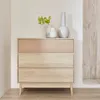 A light wood sideboard with three drawers, decorated with two vases and a plant on top, against a neutral wall. Produktbild-Vorschau