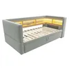 A light gray sofa bed with built-in shelving and LED lighting. Produktbild-Vorschau