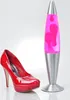 A red high-heeled shoe and a pink lava lamp are displayed against a white background. Produktbild-Vorschau